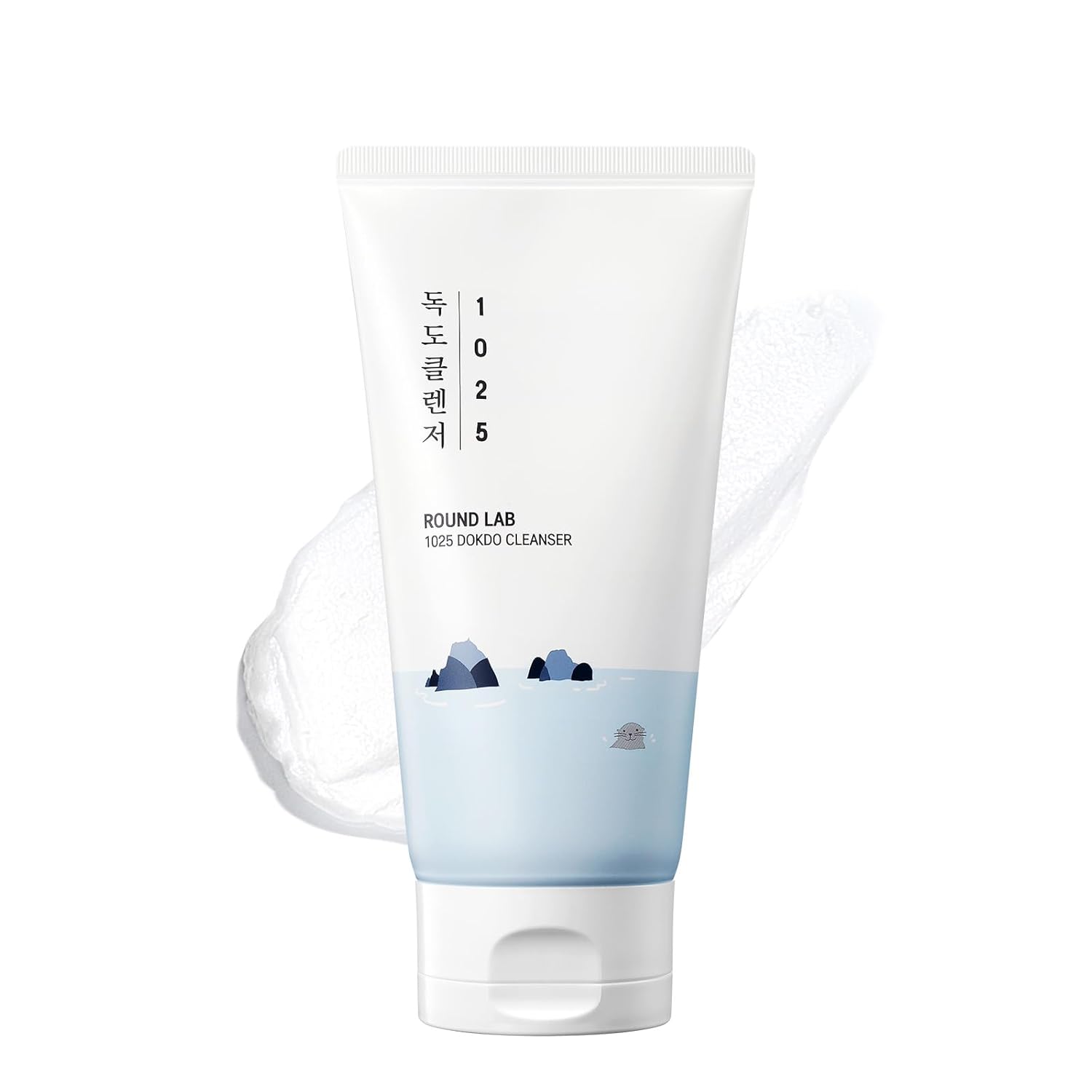 Gentle foaming facial cleanser in hand creating soft bubbles on clean white background.